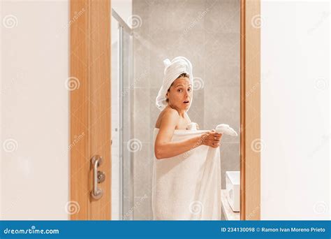 Surprised Woman Caught Unawares In Bathroom After Taking A Shower Stock