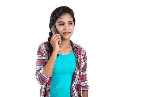 Young Indian Girl Using A Mobile Phone Or Smartphone Isolated On A Headphones Isolated