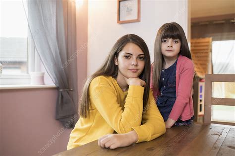 portrait brunette sisters at dining table stock image f028 7087 science photo library