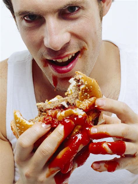Man Eating Burger Photograph By Jason Kelvinscience Photo Libray Pixels