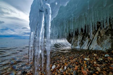 Baikal Lake In December Evening With Icicles And Stones Stock Photo