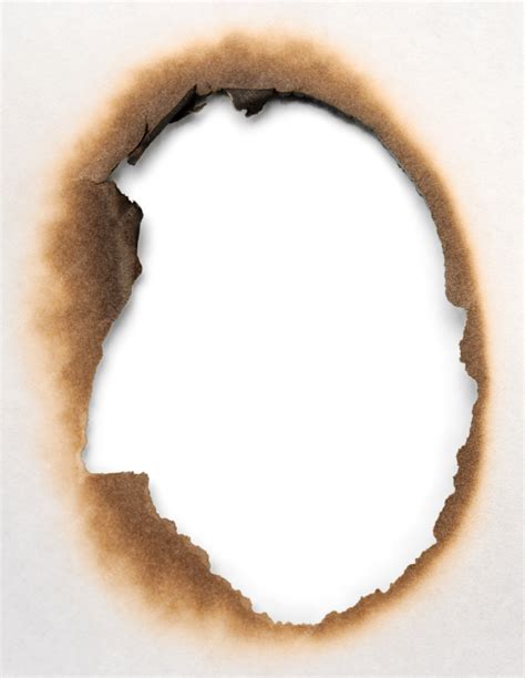 Premium Photo Close Up View Of A Burnt Hole In A Paper