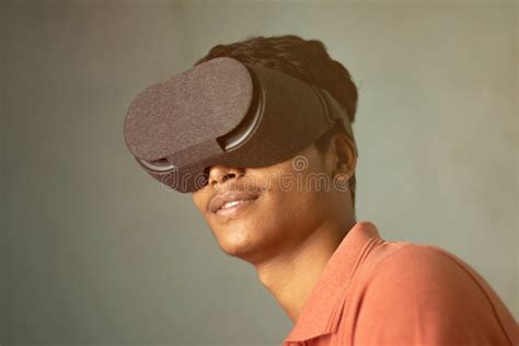Portrait Of A Young Man Experiencing Virtual Reality Through A Vr