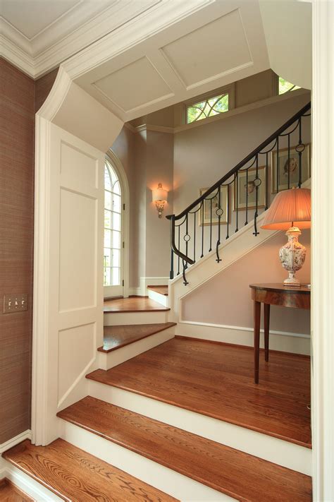 Wooden outdoor handrails add a rustic, classy and elegant look to any home. Stair landing with designed stair rails by P Gaye Tapp Interior Design. Vaughn Lighting ...