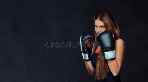 Sportive Woman Dressed In Sportswear Wearing Boxing Gloves Posing In A