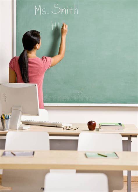 Teacher Writing On Chalk Board In Classroom Stock Image Image Of
