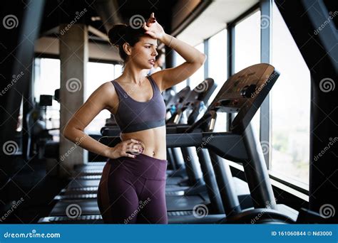Portrait Of Sporty Woman Look Tired After Workout In Gym Stock Photo