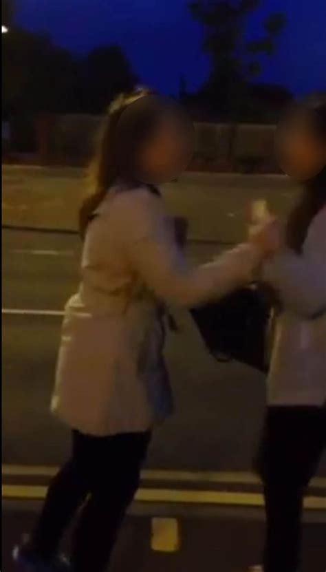 police hunt teenage bully filmed forcing girls to get on their knees and grovel to her pal