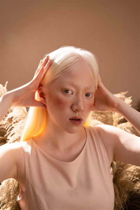 Free A Young Beautiful Albino Female Model With White Hair Posing Surrounded By Dry Grass