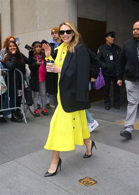 Elizabeth Olsen Wearing Yellow Dress With A Black Blazer On Top New