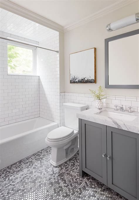 Simple bathroom with penny tile floors and a black clawfoot tub. Chic silver bathroo design with penny tile flooring | 2to5 ...