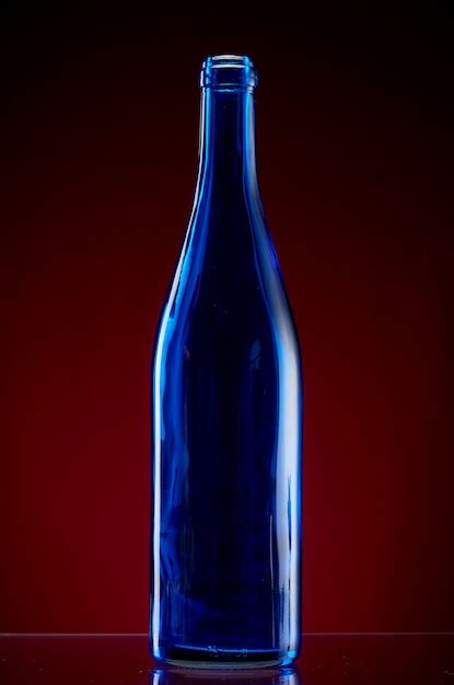 Premium Photo Dark Glass Bottle On Red