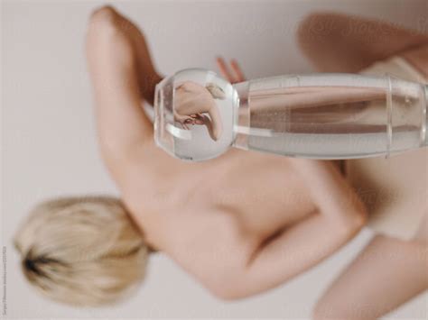 Nude Woman Reflecting Through Glass Of Water By Stocksy Contributor Sergey Filimonov Stocksy