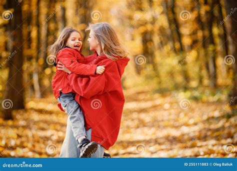 Mother And Daughter Walking And Playing In Autumn Forest Stock Image