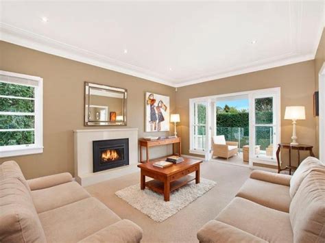 Open Plan Living Room Using Brown Colours With Carpet And Fireplace
