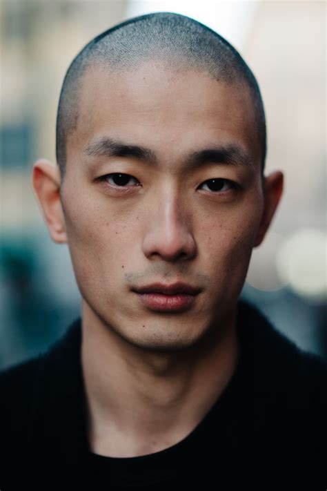 A Close Up Of A Person Wearing A Black Shirt And Looking At The Camera