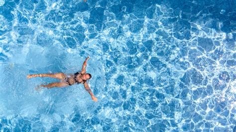 Premium Photo Active Young Girl In Swimming Pool Aerial Drone View