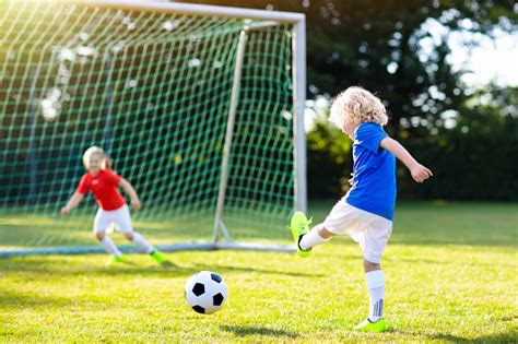 Kids Play Football Child At Soccer Field Stock Photo Download Image