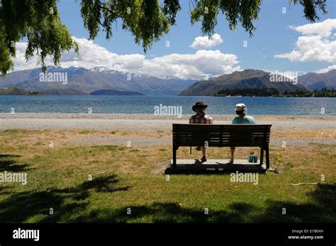 Couple Sitting On Lakeside Bench Lake Wanaka Wanaka Otago South