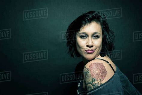 Studio Portrait Of A Woman With A Tattoo On Her Shoulder Stock Photo