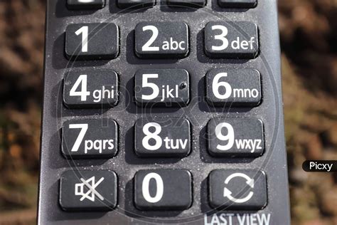 Image Of Close Up View On The Number Keys Of A Television Remote