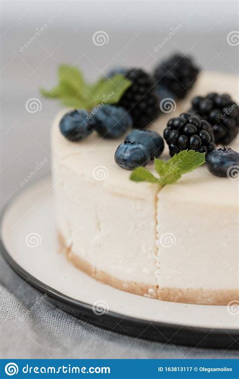 Fragments Of Classic Cheesecake With Fresh Berries On A Gray Background