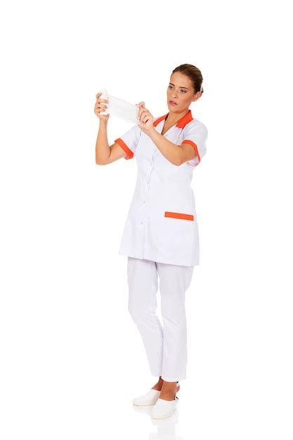 premium photo nurse holding gauze while standing against white background