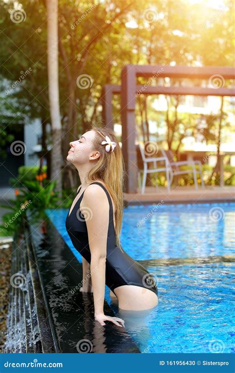 Portrait Of Young Woman Enjoy Swimming Pool Outdoors Relaxing Near