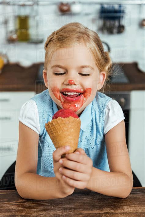 Adorable Happy Kid Eating Delicious Sweet Ice Cream Cone Stock Photo Dissolve