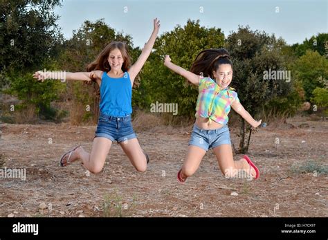 Best Friends Forever Two 12 Year Old Teenage Girls Jumping Frozen In