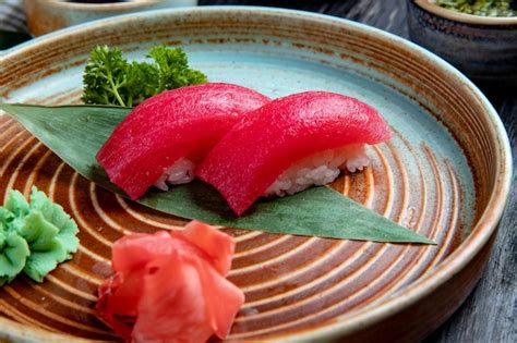 Free Photo Side View Of Nigiri Sushi With Tuna On Bamboo Leaf Served