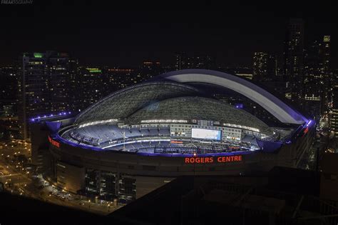 a night time view of the rogers center in downtown toronto as the dome begins to close