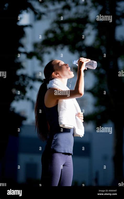 Athletic Woman Drinking Water After Jogging Stock Photo Alamy