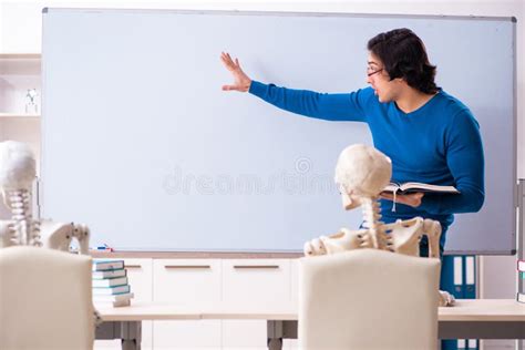 The Male Teacher And Skeleton Student In The Classroom Stock Photo