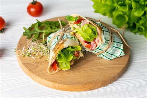 Shaurma Wrapped Sandwich With Lettuce Tomatoes Ham And Cheese Stock