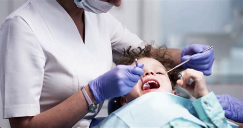 Dental examination of the oral cavity of the child. Patient in modern ...