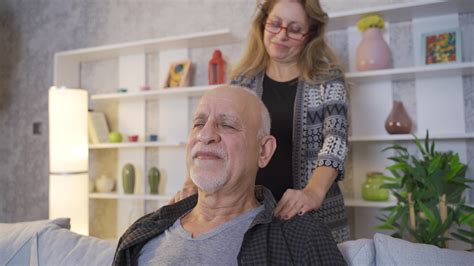 Happy Old Husband And Wife Massage Each Other The Woman Is Massaging Her Husband And The Man