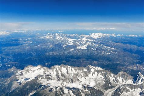 Landscape Aerial View Of Alps Mountains With Clouds And Fog Above