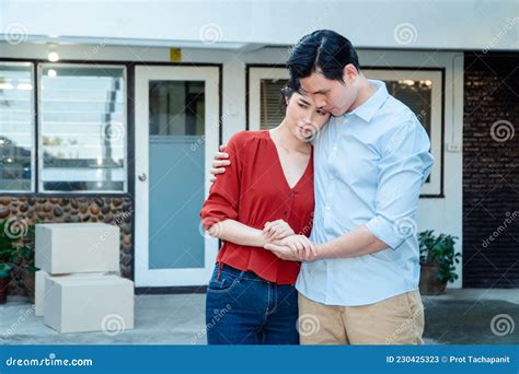 Man Comforting His Wife And Woman Hugging Her Husband And Cry In Front