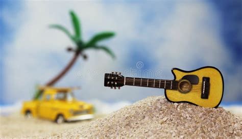 Guitar On Tropical Beach With Vintage Hot Rod In Background Stock Image