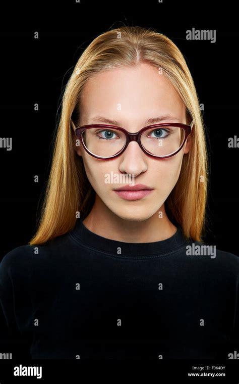 Front View Of Young Blonde Woman With Nerd Glasses Looking Seriously