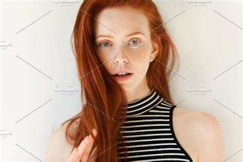 Studio Portrait Of Attractive Young Caucasian Redhead Female Looking