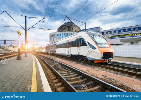 High Speed Train On The Railway Station At Sunset Stock Photo Image