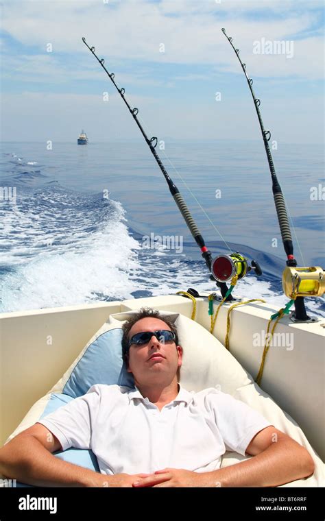Sailor Man Fishing Resting In Boat Summer Vacation Blue Sea Stock Photo