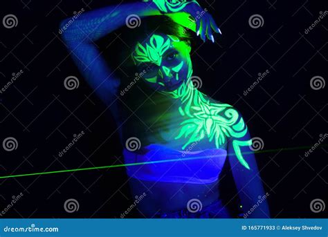 Body Art On The Body And Hand Of A Girl Glowing In The Ultraviolet