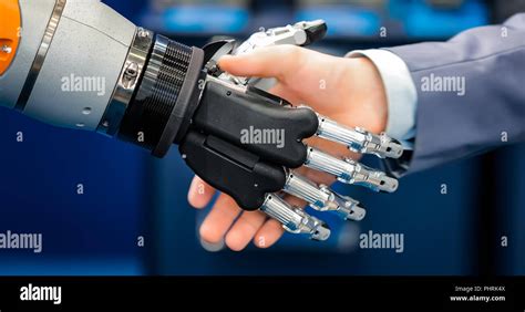 Hand Of A Businessman Shaking Hands With A Droid Robot The Concept Of