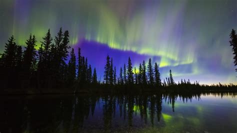 The Aurora Borealis Reflects In The Clearwater River In