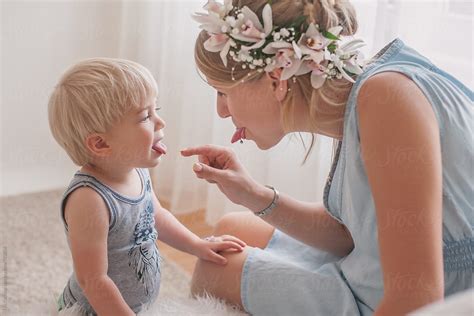 Beautiful Mother And Her Son Sticking Their Tongues Out And Having Fun