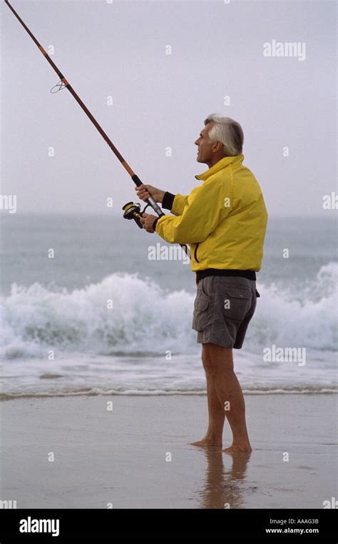 Senior Man Fishing On The Beach Stock Photo Alamy