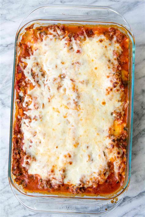 A Casserole Dish With Meat And Cheese In It On A Marble Counter Top